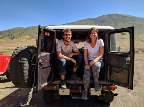 a man and woman sitting in the back of a jeep at INNI Homestay in Malang