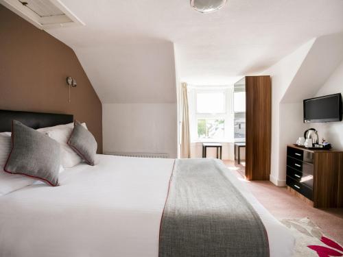 a hotel room with a bed and a television at Corner Hotel in Carnoustie