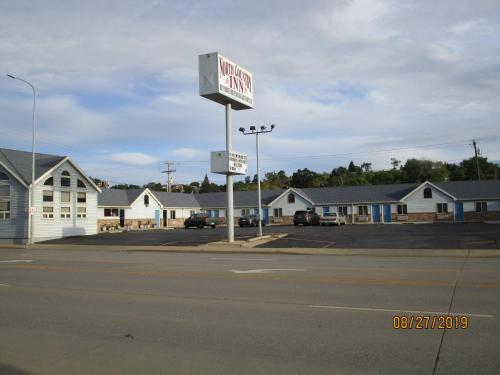 a sign for a gas station in a parking lot at North Country Inn & Suites in Mandan