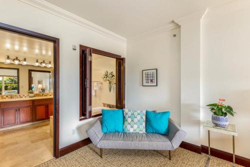 a living room with a couch and a mirror at Waipouli Beach Resort Extra Large Unit! Luxurious Decor! Sleeps up to 8* in Kapaa