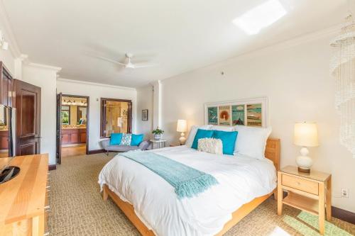 a bedroom with a large bed with blue pillows at Waipouli Beach Resort Extra Large Unit! Luxurious Decor! Sleeps up to 8* in Kapaa