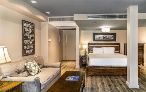 a living room with a bed and a couch at The Gallivant Times Square in New York