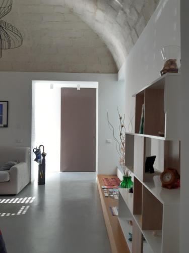 a living room with a couch and a door at Patio 101 "Exclusive" in San Vito lo Capo