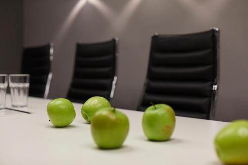 a group of green apples sitting on a table at Hotel Mirabell by Maier Privathotels in Munich