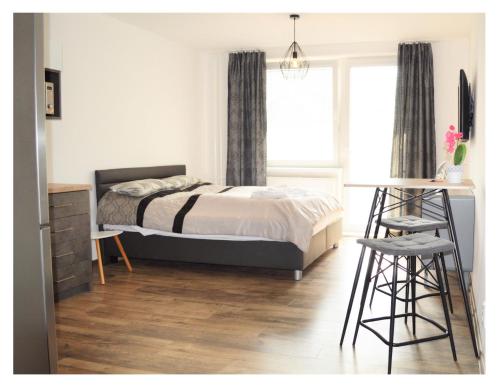 a bedroom with a bed and a desk and a chair at SGL apartments Lavickova in Trenčín