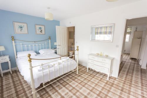 a bedroom with a bed and two dressers in it at The Bay Filey in Filey