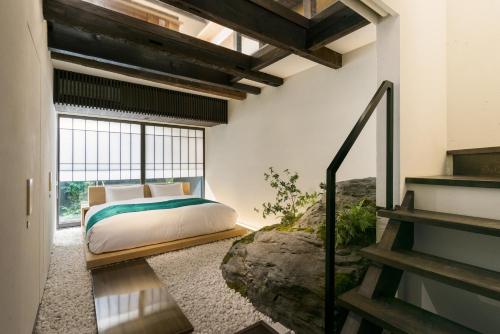 a bedroom with a bed and a large window at Kiraku Kyoto Honmachi in Kyoto