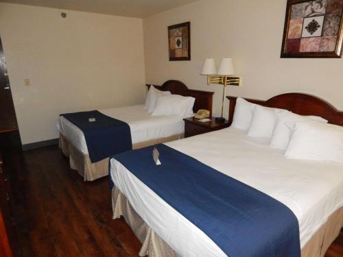 a hotel room with two beds in a room at Americas Best Value Inn Sault Ste. Marie in Sault Ste. Marie