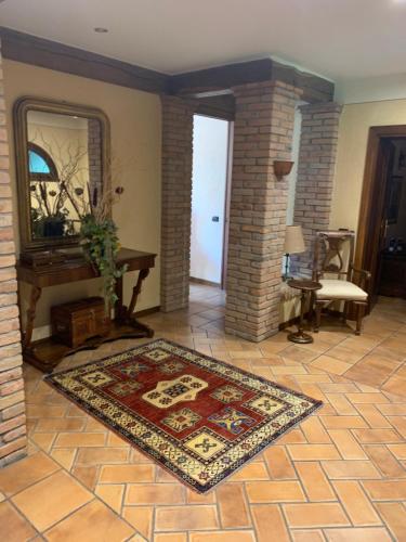 a living room with a rug on a tile floor at Da Maxim in Carpi