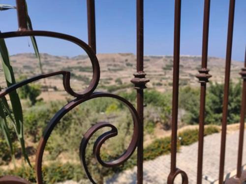 a metal railing with a view of the desert at The Loft Gozo in Xagħra