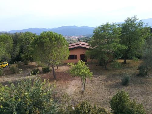 a house in the middle of a field with trees at Mas Ca La Coixa in Tortellá