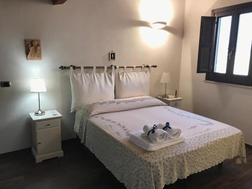a bedroom with a bed with two towels on it at Palazzo Sum Avola in Avola