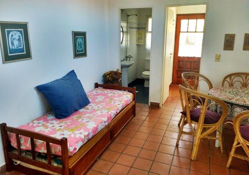 a bedroom with a bed and a table and chairs at La Casa de Kelly in Federación