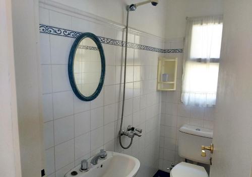 a bathroom with a mirror and a sink and a toilet at La Casa de Kelly in Federación
