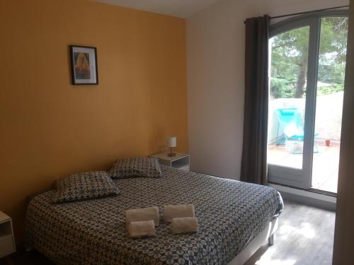 a bedroom with a bed with two pillows on it at Maison d'hôtes naturiste Villa PaulAna in Cap d'Agde