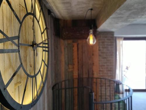 a large clock on the side of a wall at The Loft Gozo in Xagħra