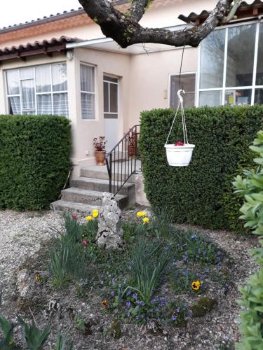 a house with a garden with flowers in front of it at Theana in Cazilhac