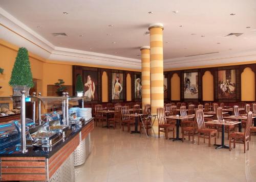 a restaurant with tables and chairs in a room at Panorama Naama Heights in Sharm El Sheikh