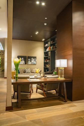 a dining room with a table and a couch at Manto Hotel Lima - MGallery Collection in Lima