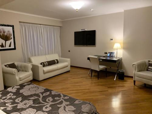 a hotel room with a bed and a desk and a television at Hotel Villa Traiano in Benevento