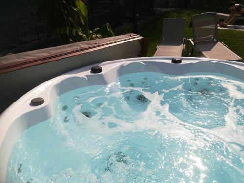 a jacuzzi tub with blue water in a yard at Locanda San Marco in Torri del Benaco