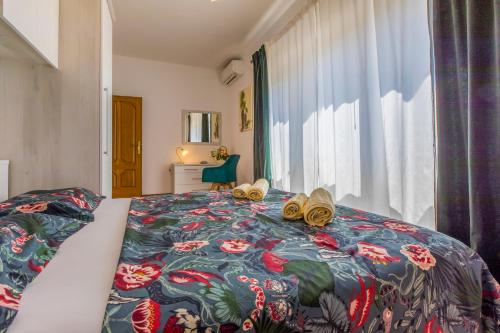 a bedroom with a bed with shoes on it at Villa M in Crikvenica