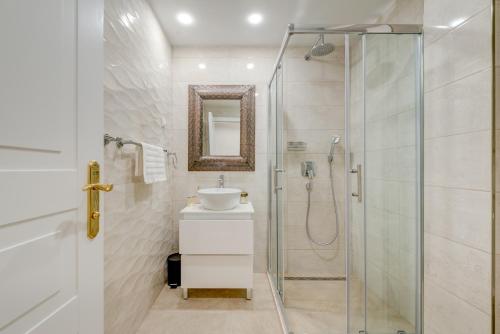 a bathroom with a glass shower and a sink at Princ Heritage Rooms in Split