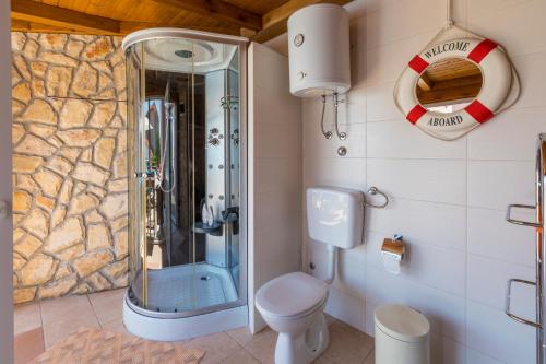 a bathroom with a shower and a toilet at Villa M in Crikvenica