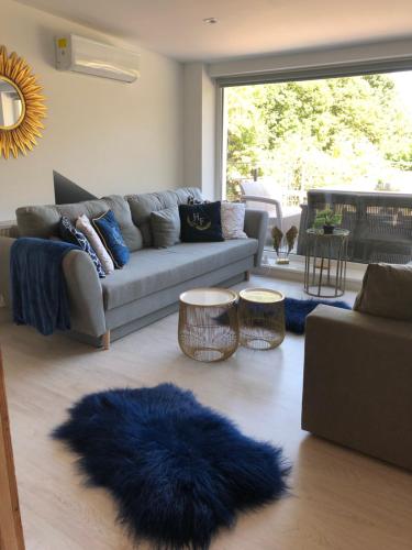 a living room with a couch and a blue rug at Comfort Zone Ostróda Ruś Mała in Ostróda