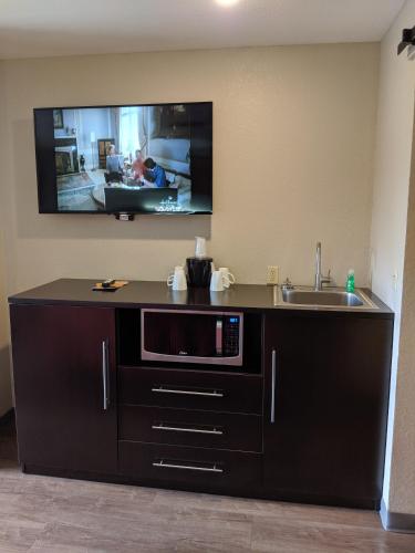 a kitchen with a sink and a tv on the wall at Riverside Tower in Pigeon Forge