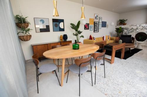 a living room with a wooden table and chairs at Casa Ixaya by Barrio México in Guadalajara
