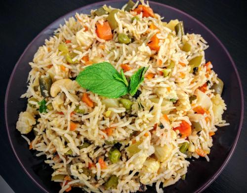 a plate of food with rice and vegetables at Sara Hotels and Apartments in Nedumbassery