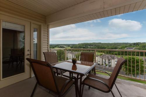 a patio with a table and chairs on a balcony at Luxury Condos at Thousand Hills - Heart of Branson - Beautifully remodeled - Spacious and Affordable in Branson