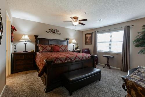 a bedroom with a bed and a ceiling fan at Luxury Condos at Thousand Hills - Heart of Branson - Beautifully remodeled - Spacious and Affordable in Branson