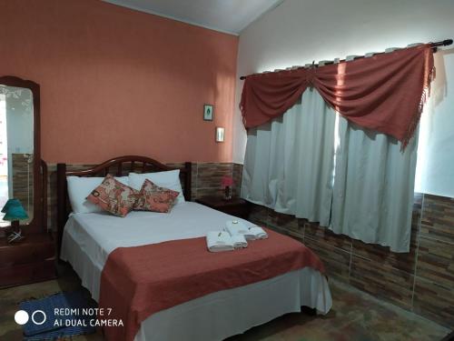 a hotel room with a bed and a window at Pouso do Elefante in Serra do Cipo