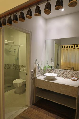 a bathroom with a sink and a toilet at Amazon Ecopark Jungle Lodge in Manaus