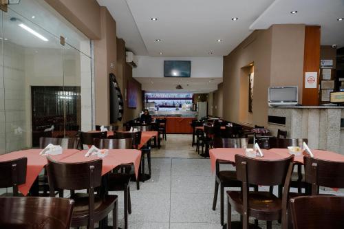 a dining room with tables and chairs and a restaurant at Tucuman Palace Hotel in Buenos Aires