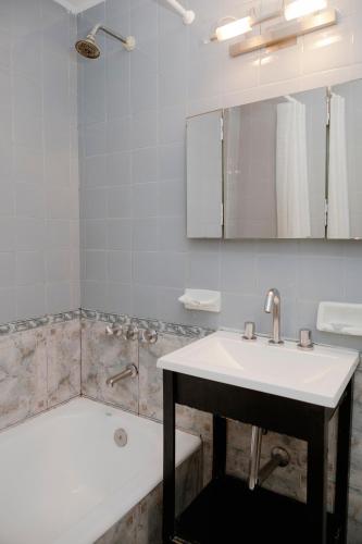 a bathroom with a sink and a bath tub at Tucuman Palace Hotel in Buenos Aires