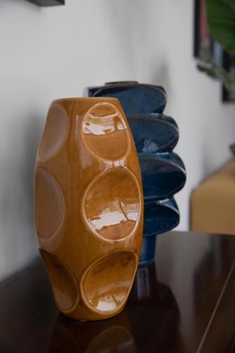 a brown and blue vase sitting on a table at Casa Ixaya by Barrio México in Guadalajara