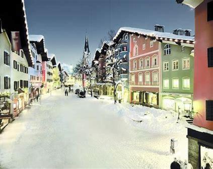 a snow covered street in a city with buildings at Posthof 33 in Kitzbühel