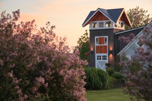 a house with pink flowers in front of it at The Inn at Abeja in Walla Walla