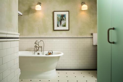 a bathroom with a white tub and a sink at The Inn at Abeja in Walla Walla