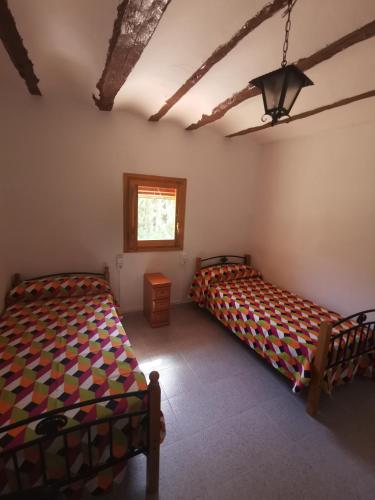 A bed or beds in a room at Casa Rural y Albergue Tormon