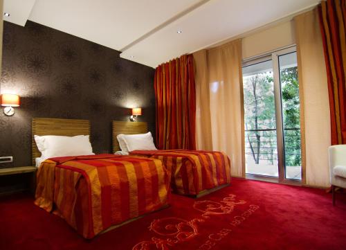 En eller flere senger på et rom på GRANDE CASA Hotel - Međugorje