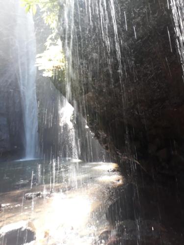 a waterfall with water coming out of it at Sugi Gede Homestay in Singaraja