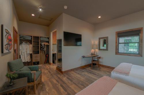 a bedroom with a bed and a desk in a room at Golden Stone Inn in West Yellowstone