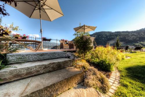 a set of stairs with an umbrella in a yard at AlpinApart Bacher in Serfaus