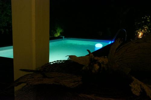 a view of a swimming pool at night at Villa SoFi in Saint-François