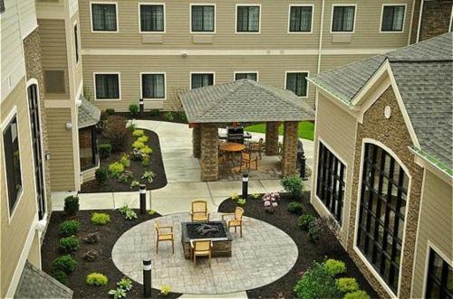 an aerial view of a patio in front of a building at Staybridge Suites Williamsville Buffalo by IHG in Williamsville