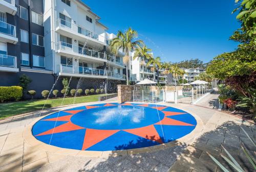 a basketball court in front of a building at Mantra Nelson Bay in Nelson Bay